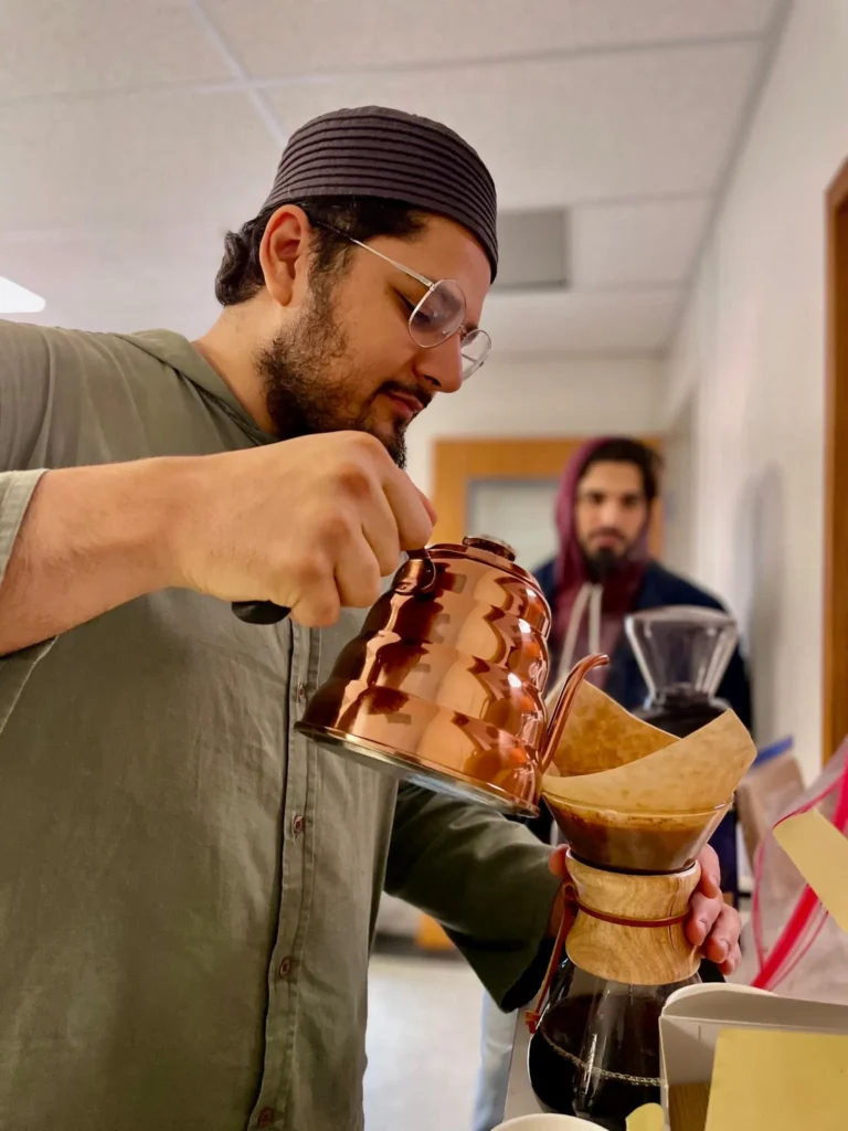 Coffee being poured at a Spilling Beans gathering